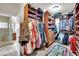 Large walk-in closet with built-in shelving and racks for ample storage and door to bathroom at 116 N Ring Dove Dr, Las Vegas, NV 89144