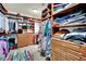 Large walk-in closet with built-in shelving and racks for ample storage and ottoman at 116 N Ring Dove Dr, Las Vegas, NV 89144