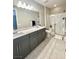 Modern bathroom with a double vanity, framed mirror, and glass-enclosed shower at 11703 Emerald Lake Ave, Las Vegas, NV 89138