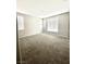 Spacious bedroom with neutral walls, carpeted floor, and bright windows with blinds at 11703 Emerald Lake Ave, Las Vegas, NV 89138