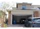 Home exterior featuring attached two car garage with a modern car parked in the driveway at 11703 Emerald Lake Ave, Las Vegas, NV 89138