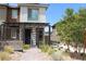 Charming two-story home featuring a modern exterior, pergola over the entrance, and drought-resistant landscaping at 11703 Emerald Lake Ave, Las Vegas, NV 89138