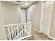 Bright upstairs hallway featuring neutral tones, white trim, and carpet flooring at 11703 Emerald Lake Ave, Las Vegas, NV 89138