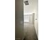 Neutral hallway with carpeted floor leading into a room with a window and blinds at 11703 Emerald Lake Ave, Las Vegas, NV 89138