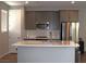 Modern kitchen showcasing gray cabinets, stainless steel appliances, and center island with quartz countertops at 11703 Emerald Lake Ave, Las Vegas, NV 89138