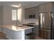 Modern kitchen featuring gray cabinets, stainless steel appliances, and a center island with quartz countertop at 11703 Emerald Lake Ave, Las Vegas, NV 89138