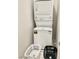 Efficient stacked washer and dryer unit with laundry supplies at 11703 Emerald Lake Ave, Las Vegas, NV 89138