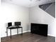 Bright living room with hardwood floors, staircase, and modern media setup, perfect for entertainment at 11703 Emerald Lake Ave, Las Vegas, NV 89138