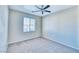 A simple bedroom featuring neutral walls, soft carpet, and a bright window at 1813 Arch Stone Ave, North Las Vegas, NV 89031