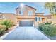 Inviting two-story home with desert landscaping and an attached two-car garage at 1813 Arch Stone Ave, North Las Vegas, NV 89031