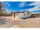 Spacious backyard with stone pavers and a rock landscaping and a white exterior at 1813 Pluto Dr, Las Vegas, NV 89108