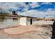 The backyard features a patio, a covered outdoor space, desert landscaping and mature trees at 1813 Pluto Dr, Las Vegas, NV 89108