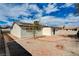 A cozy backyard featuring desert landscaping, a covered patio, and plenty of space for outdoor activities, plus solar panels at 1813 Pluto Dr, Las Vegas, NV 89108