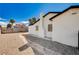 Spacious backyard featuring a side yard with rock landscaping, a brick chimney, and a fence at 1813 Pluto Dr, Las Vegas, NV 89108