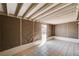 The unfinished basement boasts neutral colors, tile floor, and exposed overhead rafters at 1813 Pluto Dr, Las Vegas, NV 89108