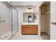 Bright bathroom featuring a glass enclosed shower, single sink vanity, and a closet with shelving at 1813 Pluto Dr, Las Vegas, NV 89108