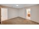 Corner view of bright bedroom featuring plush carpet leading into a tiled bathroom at 1813 Pluto Dr, Las Vegas, NV 89108