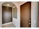 Exterior entrance featuring a brown front door and a side door with a window at 1813 Pluto Dr, Las Vegas, NV 89108