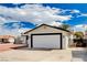 Side view of house with white garage door and black trim at 1813 Pluto Dr, Las Vegas, NV 89108