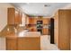 Kitchen with wood cabinetry, tile backsplash, and stainless steel appliances at 1813 Pluto Dr, Las Vegas, NV 89108