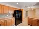 Spacious kitchen with wood cabinets, tile floors, and stainless steel refrigerator at 1813 Pluto Dr, Las Vegas, NV 89108