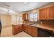 Charming kitchen with oak wood cabinets, tile floors, and lots of natural light at 1813 Pluto Dr, Las Vegas, NV 89108