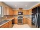 Functional kitchen with modern appliances, wood cabinets, and ample counter space at 1813 Pluto Dr, Las Vegas, NV 89108