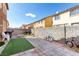 The spacious backyard has a block wall, patio pavers, and artificial turf, perfect for outdoor activities and landscaping at 1930 Silver Crest Ct, North Las Vegas, NV 89031