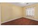 Bedroom featuring yellow paint, wood-look floors, and a window with floral curtains at 1930 Silver Crest Ct, North Las Vegas, NV 89031
