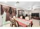 Dining room with an elegant table setting, decorative curtains, and adjacent entertainment area at 1930 Silver Crest Ct, North Las Vegas, NV 89031
