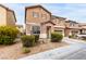 Charming two-story home with a well-maintained front yard, desert landscaping, and attached garage at 1930 Silver Crest Ct, North Las Vegas, NV 89031