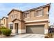 Two-story home featuring a low maintenance yard, desert landscaping, and an attached garage at 1930 Silver Crest Ct, North Las Vegas, NV 89031