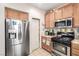 Functional kitchen with stainless steel appliances, ample cabinet space, and a view of a pantry door at 1930 Silver Crest Ct, North Las Vegas, NV 89031