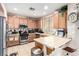 Charming kitchen with stainless steel appliances and wooden cabinets with decorative décor and breakfast bar at 1930 Silver Crest Ct, North Las Vegas, NV 89031