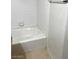 This bathroom features a white tub and shower with tile surround at 2110 Los Feliz St # 2037, Las Vegas, NV 89156