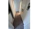 Narrow hallway featuring neutral carpet, leading to multiple rooms with storage and a laundry area at 2110 Los Feliz St # 2037, Las Vegas, NV 89156