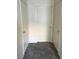 Hallway featuring neutral carpet and three white doors at 2110 Los Feliz St # 2037, Las Vegas, NV 89156