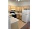 Functional kitchen features wood cabinets, white countertops, and essential appliances, ready for everyday cooking at 2110 Los Feliz St # 2037, Las Vegas, NV 89156