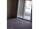 Living room sliding doors lead to a private balcony with city views at 2110 Los Feliz St # 2037, Las Vegas, NV 89156