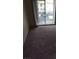 View of a bright living room leading to a balcony with sliding glass doors, offering outdoor views at 2110 Los Feliz St # 2037, Las Vegas, NV 89156