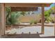 Covered patio overlooking the backyard featuring desert landscaping and block wall fencing at 2137 Hidden Ranch Ter, Henderson, NV 89052
