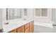 This modern bathroom features a double sink vanity, a tub, and a window for natural light at 2137 Hidden Ranch Ter, Henderson, NV 89052