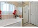 Bathroom showcasing a shower stall with a glass door and a built in tub at 2137 Hidden Ranch Ter, Henderson, NV 89052
