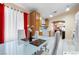 Bright dining area featuring a modern glass-top table and red accents at 2137 Hidden Ranch Ter, Henderson, NV 89052