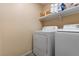 Laundry area with a white washer and dryer and overhead shelving at 2137 Hidden Ranch Ter, Henderson, NV 89052