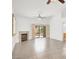 Open floor plan with living room featuring a fireplace, tile floors, and access to the backyard at 2137 Hidden Ranch Ter, Henderson, NV 89052