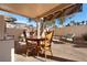 Covered patio with gravel flooring and an outdoor dining set at 2137 Hidden Ranch Ter, Henderson, NV 89052