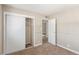 This is a carpeted bedroom with a closet and access to another room at 2232 Valley Dr, Las Vegas, NV 89108