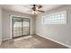 Carpeted bedroom features a sliding glass door and a large window at 2232 Valley Dr, Las Vegas, NV 89108