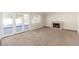 Spacious living room featuring sliding glass doors, plush carpet and a fireplace at 2232 Valley Dr, Las Vegas, NV 89108